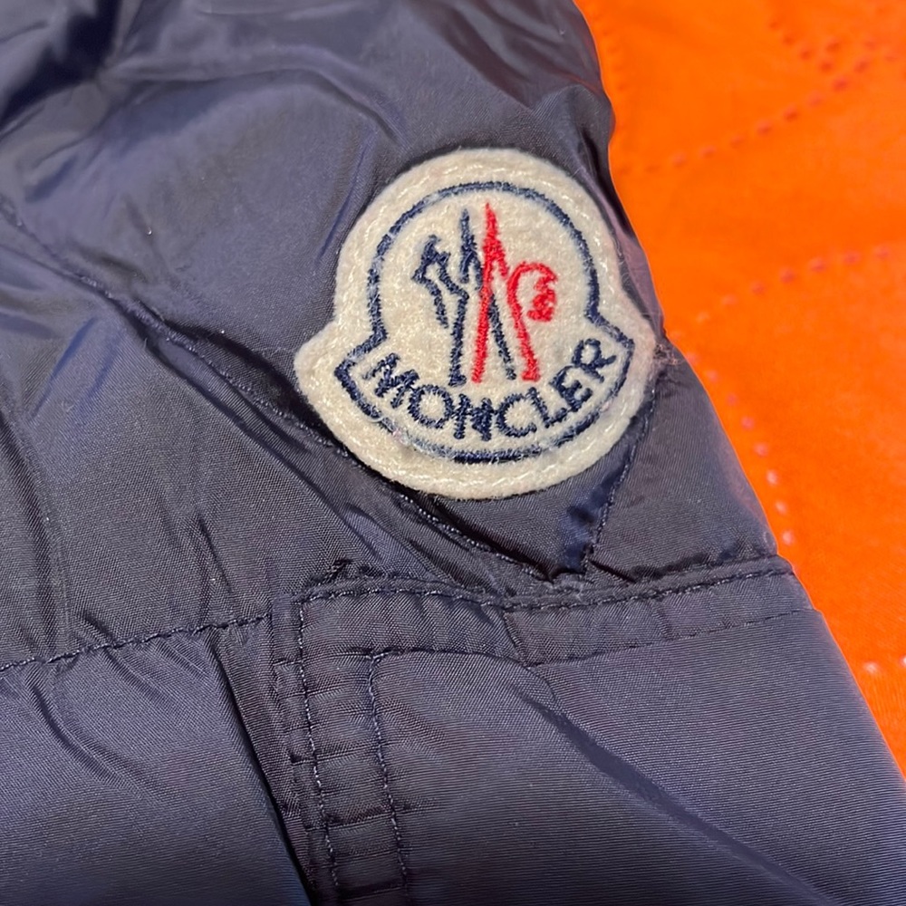 Moncler black puffer jacket with blue interior. Smoke free home.